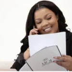 House of Intelligence consultant on a phone call holding an HOI Marketing folder